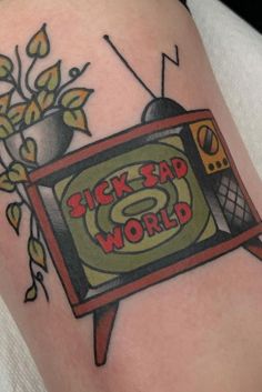 a tattoo on the arm of a person with a tv and flowers in front of it