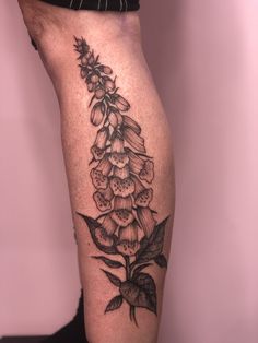 a black and white flower tattoo on the leg