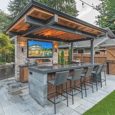 an outdoor entertainment area with bar and grill