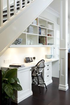 a home office under the stairs in a house