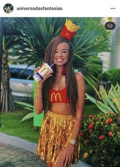 a woman in a yellow skirt holding a drink and wearing a mcdonald's hat