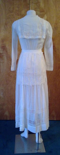 "Edwardian lingerie dress. Sheer white fabric with gorgeous lace inserts and trim. Wide sailor style collar . Bodice opens to a deep v. Front and back apron like panels. This is in such great condition for a dress that's 100 years old. No stains or holes. I made one repair to a break in the insert lace in one of the lower tiers of the skirt. All the hook and eye closures are missing so you will need to add them. Shown on my mannequin 34 1/2\" bust, 26\" waist. 36\" hips My measurement taken flat White Victorian Empire Waist Dress, Cottagecore Day Dress With Lace Trim, Cottagecore Dresses With Lace Trim For Daywear, White Victorian Dress For Daywear, White Elegant Victorian Dress With Broderie Anglaise, Victorian White Dress For Daywear, Cottagecore Daywear Dress With Lace Trim, Fitted Cotton Lace Broderie Anglaise Dress, White Victorian Daywear Dress