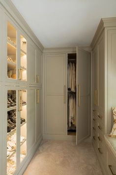 an empty walk in closet with lots of clothes