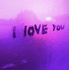 the word i love you is written in black ink on a purple background with fog