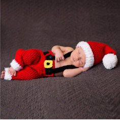 a newborn baby wearing a santa suit and hat