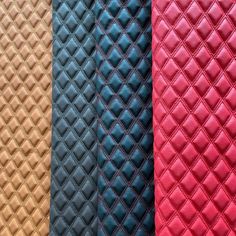 four different colors of quilted material are lined up in rows, each with an interesting diamond pattern