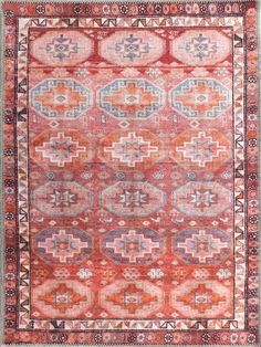 an old rug with many different colors and patterns on the carpet, including pinks