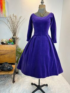 1950s dress / 50s dress / 1950s velvet dress / purple velvet dress This is a gorgeous 1950s dress. This vibrant velvet purple dress has the classic fit and flare cut with bonuses that make it an exaggerated curve hugger. Just look at her tailored low back line. Truly gorgeous craftsmanship and made by Jonny Herbert. The velvet is deep and vibrant with no color fade! Measurements provided are flat and have been doubled. Bust 34" Waist 24" Hips free Length 39" ❤️ Condition: Excellent vintage condition. Flaw: none found.This item has been cleaned and is ready to wear. $178 includes domestic shipping and insurance. International shipping is $30. Please let me know if you have questions, would like more measurements, or photos. I am here to help. 💜Megan Velvet Purple Dress, Purple Velvet Dress, Velvet Purple, 50s Dresses, 1950s Dress, Dress Purple, Purple Velvet, No Color, Velvet Dress