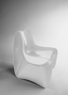 a white chair sitting on top of a white floor