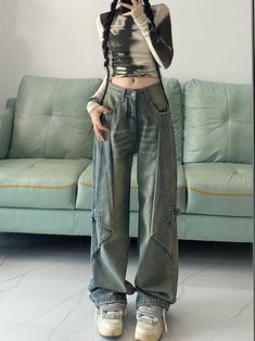 Venturing into the realm of avant-garde fashion, these jeans present an extraordinary statement with their oversized, ultra-wide-leg design. The faded blue denim is a nod to the classic, while the exaggerated silhouette pushes boundaries, making these jeans a piece for the bold at heart. The structured waistband and pockets retain a sense of traditional denim styling, but the paneled legs with their pronounced seams and cargo-style pockets introduce an urban utility vibe. These jeans are for tho Stonewashed Jeans Outfit, Edgy Baggy Wide Leg Jeans, Faded Baggy Wide Leg Cargo Jeans, Baggy Faded Wide Leg Cargo Jeans, Baggy Wide Leg Cargo Jeans In Faded Color, Faded Baggy Wide-leg Cargo Jeans, Faded High Waist Baggy Flare Jeans, Faded Baggy High Waist Flare Jeans, Grunge Style Medium Wash Wide Leg Flare Jeans