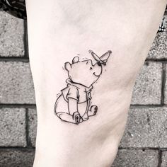 a small tattoo on the ankle of a person's foot with a teddy bear