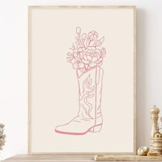 a drawing of a cowboy boot with flowers in it on a shelf next to a potted plant