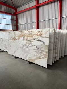 marble counter tops are lined up in a warehouse