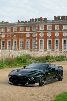 a black sports car parked in front of a large building