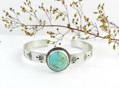 Handmade solid sterling silver turquoise organic cuff.  A pastel blue Carico Lake USA Mine, turquoise round set in sterling and fine silver. I hand stamped a stylized dot and fan pattern on the cuff and framed the turquoise in smooth fine silver. Oxidized, tumbled and hand polished for detail.  The beautiful chunky Carico Lake turquoise from Nevada, a gorgeous soft blue-green turquoise with earthy brown matrix. So pretty!  Entirely hand fabricated. Nice weight and super sturdy 14 gauge sterling Bohemian Stamped Turquoise Ring Gift, Bohemian Turquoise Sterling Silver Cuff Bracelet, Stamped Turquoise Cuff Bracelet Gift, Stamped Turquoise Bracelet As Gift, Artisan Round Turquoise Cuff Bracelet, Turquoise Stamped Cuff Bracelet As Gift, Gift Turquoise Stamped Cuff Bracelet, Silver Hand-stamped Bohemian Jewelry, Hand Stamped Silver Bohemian Jewelry