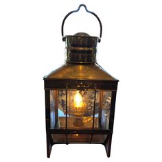 an old fashioned lantern with a lit candle inside