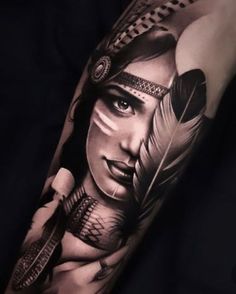 a woman's arm with an arrow and feathers on it