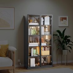 a book case with many books in it next to a chair and potted plant