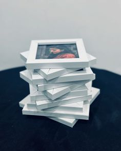 a stack of white stacked photos on top of each other