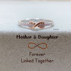 With a meaningful message card included, this ring is the perfect gift for either mom or daughter. It also serves as a reminder that the love between mother and daughter is forever linked together. CARD MESSAGE Mother & Daughter Forever Linked Together. SPECIFICATIONS Size: US 5-10 Stone: AAA Grade Cubic Zirconia Metal: 925 Sterling Silver WHAT'S IN THE BOX 1*Mother Daughter Ring 1*Full-designed gift card 1*Silver polishing cloth 1*Free box If you have any questions about the ring, please contac Personalized Infinity Rings For Anniversary, Infinity Promise Rings For Mother's Day, Mother's Day Infinity Adjustable Rings, Adjustable Infinity Ring For Mother's Day, Adjustable Infinity Stackable Anniversary Rings, Adjustable Infinity Stackable Rings For Anniversary, Dainty Infinity Stackable Rings For Gift, Personalized Adjustable Infinity Rings, Dainty Infinity Stackable Rings As Gift