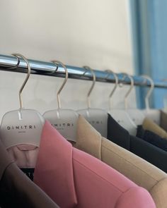 clothes hangers with different colored shirts on them