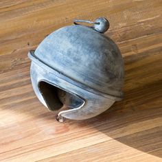 an old metal object sitting on top of a wooden floor