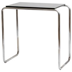 a metal and glass side table on a white background