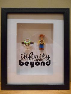 two legos in a frame with the words, to infinity over and beyond on it