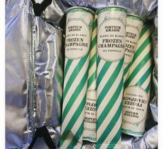 three green and white candy canes sitting on top of tinfoil wrapped in foil