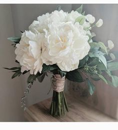 a bouquet of white flowers sitting on top of a table