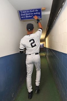 a baseball player is holding up a sign