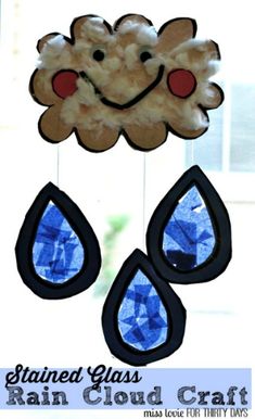 a wind catcher made out of stained glass with rain drops hanging from it's sides