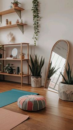 a room with various plants and yoga mats on the floor, including a round pillow