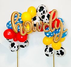 there are some balloons that say happy on the top of each balloon and one has a dalmatian pattern