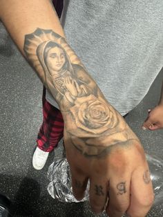 a person with a tattoo on their hand