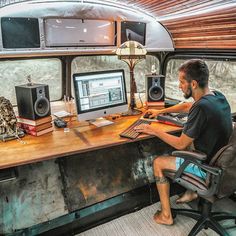 a man sitting at a desk in front of a computer