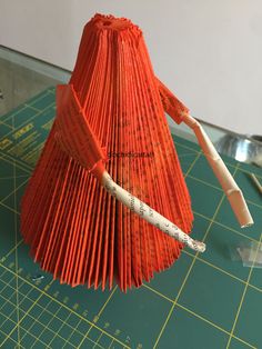 an origami umbrella is on a cutting board