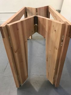 an unfinished wooden table with four sections cut out