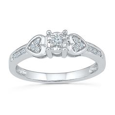 a white gold ring with diamonds on the sides and an open heart design in the middle