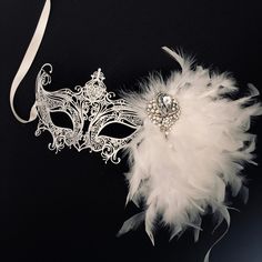 White masquerade mask women diner en blanc mask venetian masked ball This versatile Feather fascinator can be clipped on and attached to head or mask. Womens White metal Masquerade mask with white feathers. Also available in a variety of colors. S H I P P I N G - Processed same day or within 24 hours. 1-2 day guaranteed delivery services offered, add items to cart and click on shipping tab for rates. Pls leave a check out note with your need date & contact number (especially for expedited an Mascarade Ball Dresses, Wedding Masquerade, White Masquerade Mask, White Masquerade, Masquerade Mask Women, Elegant Face Mask, Mask Venetian, Mask White, Metal Mask