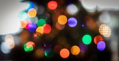 a blurry christmas tree with multicolored lights