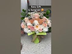 a bouquet of flowers sitting on top of a counter next to a sign that says easy gift & surprise