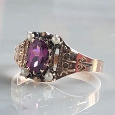 Details: Beautiful Victorian Garnet and Seed Pearl ring set in lovely 14K rose gold. The band is adorned in lovely abstract filigree engraving. The stone has great depth, and has a lovely rich pink tint to the garnet. It is surrounded by 4 seed pearls. The garnet measures 7.5mm x 5mm. There are no internal markings. Measurements: Ring measures a size 7 3/4 US. It can be re-sized for a fee. Condition: The overall all condition of this ring is very good. Please ask all questions prior to placing a Elegant Rose Gold Engraved Ring Stamped 14k, Rose Gold Oval Engraved Ring Fine Jewelry, Oval Rose Gold Engraved Ring In Fine Jewelry Style, Oval Engraved Rose Gold Ring Fine Jewelry, Oval Engraved Rose Gold Ring, Antique 14k Rose Gold Rings, Heirloom 14k Rose Gold Oval Jewelry, Victorian Rose Gold Ruby Ring, Heirloom Oval 14k Rose Gold Jewelry