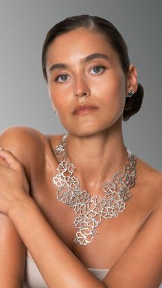 Woman wearing a large silver collier inspired by flowers. Master Piece, Dramatic Look, Garden Of Eden, Floral Jewellery