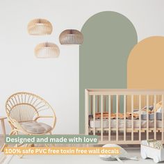 a baby's room with a crib, rocking chair and wall decals