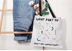 a tote bag that says what part of don't you understand? next to jeans