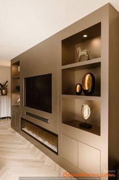 a modern living room with built in shelves and a flat screen tv mounted on the wall