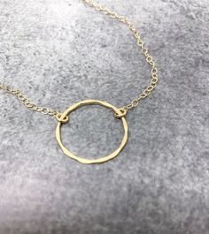 Gold Circle NecklaceThis dainty gold open circle necklace features a beautifully hammered circle delicately suspended from a strong, but dainty gold filled chain. The perfect minimalist necklace!  Available in sterling silver or gold.-26mm gold filled hammered circle.-Dainty gold filled cable chain.- I do offer a gift wrapping option for gift giving purposes.GOLD-FILLED JEWELRY:- 14kt Gold filled offers an economical alternative to solid gold.- 14kt Gold filled jewelry is made by bonding a solid Dainty Jewelry With Delicate Open Circle Chain, Dainty Open Circle Jewelry With Delicate Chain, Gold Minimalist Open Circle Charm Necklace, Minimalist Gold Open Circle Charm Necklace, Dainty 14k Gold Filled Circular Jewelry, Gold Open Circle Jewelry With Delicate Chain, Gold Jewelry With Delicate Chain And Open Circle, Gold Jewelry With Delicate Open Circle Chain, Gold Jewelry With Delicate Chain In Open Circle