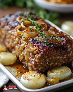 meatloaf with onions and herbs on a plate