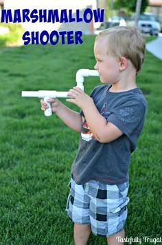 a young boy is playing with a homemade marshmallow shooter in the grass and text overlay reads, how to make an easy marshmallow shooter